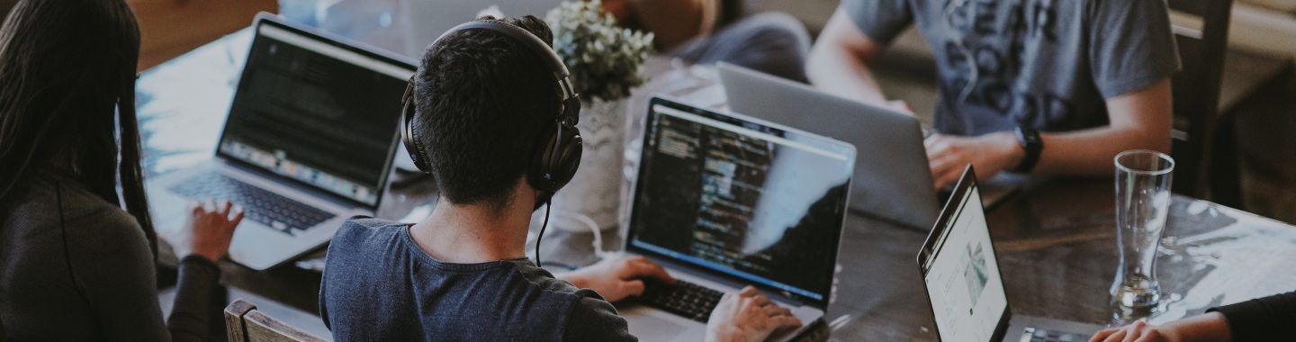 a group of people working together using their computers