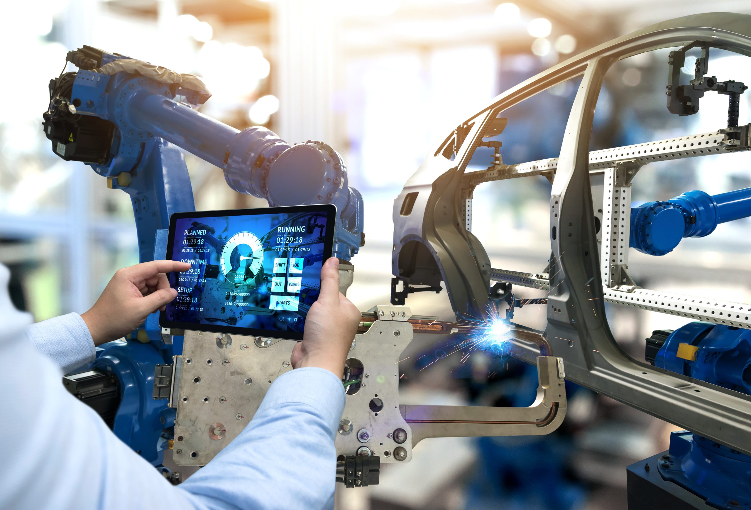 Engineer hand using tablet with machine real time monitoring sys