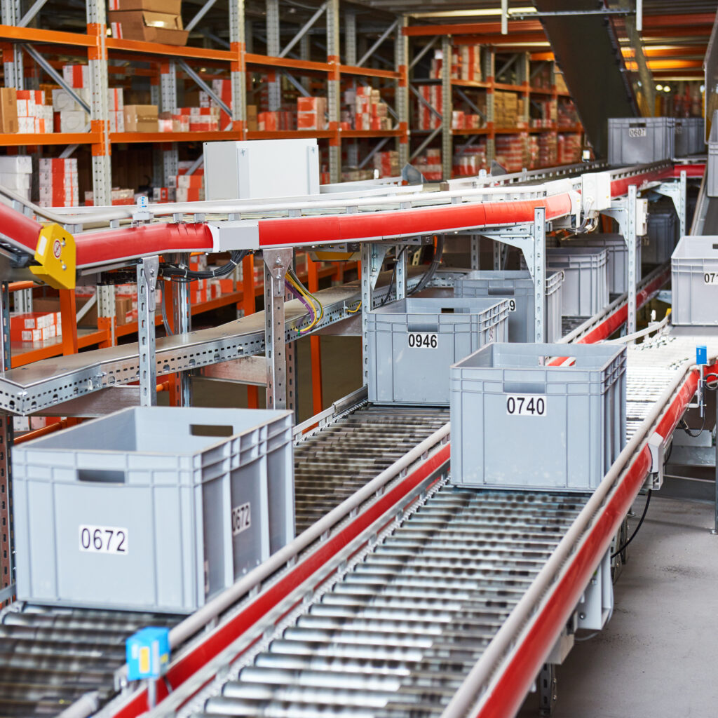 Automated warehouse. Boxes with spare parts moving on conveyer